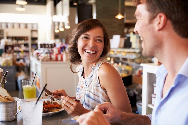 Couple eating in a restaurant laughing