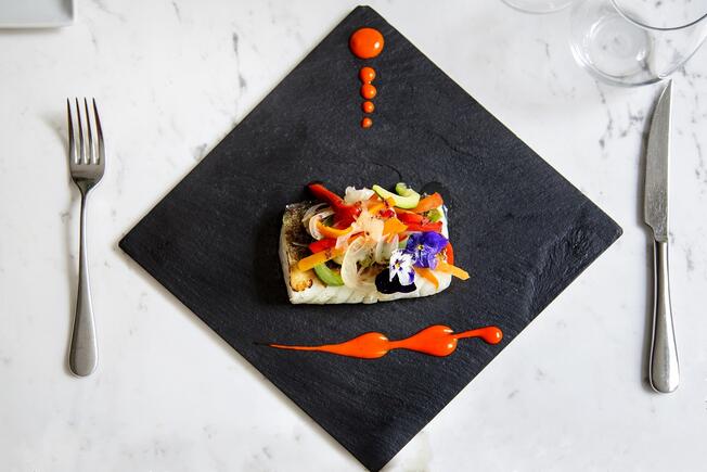 Fish food in a black plate 