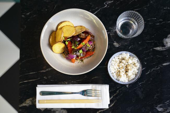 restaurant plate with roasted vegetables and bowl of rice
