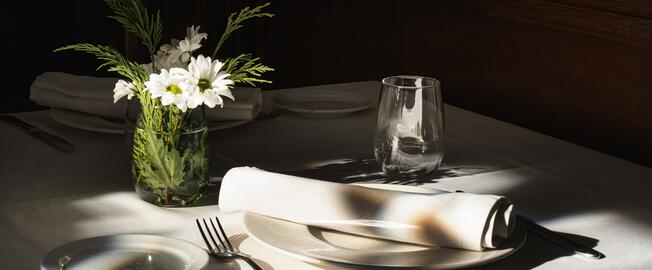 restaurant table with plate and flower pot