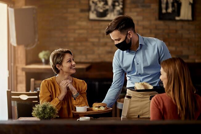 Waiter serving two girls